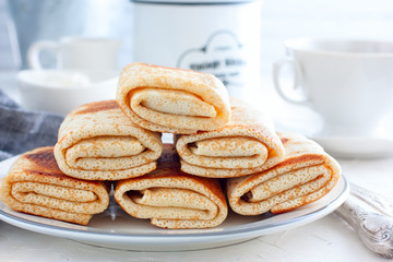 Stuffed with meat fried pancakes on a traditional carnival on a white table, horizontal