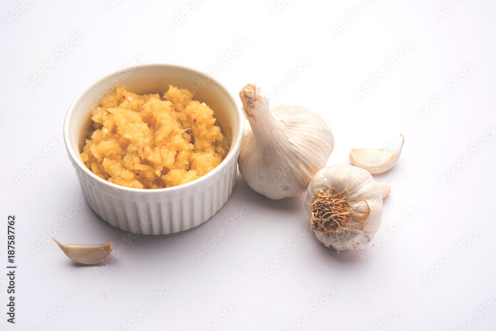 Wall mural garlic paste or toum or toumya with raw garlic, isolated over white background