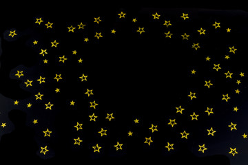 background of golden glitter particles stars on black background,happy with copy space on the middle