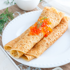 Homemade pancakes with red caviar for carnival, square