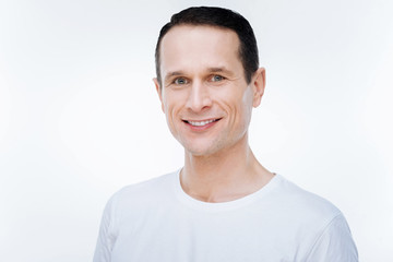 Positive mood. Nice positive happy man smiling and looking at you while having a good mood