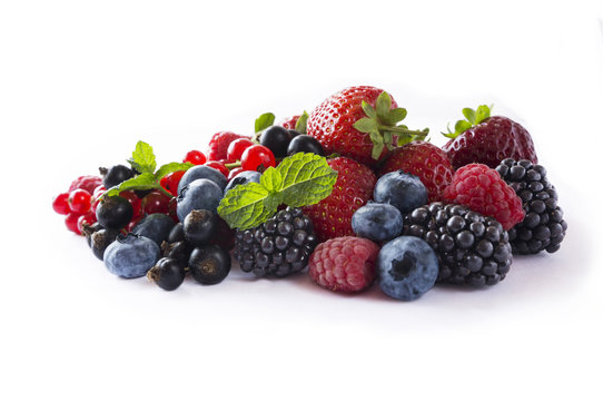 Ripe blueberries, blackberries, red currants, black currant, raspberries and strawberries. Mix berries isolated on a white. Various fresh summer berries on white background.
