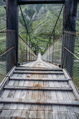 Close up view of wooden bridge and tourists in Himalayas mountains, Altai, Russia