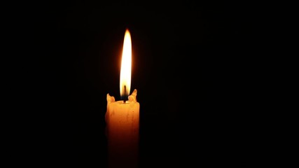 Single lit candle with quite flame