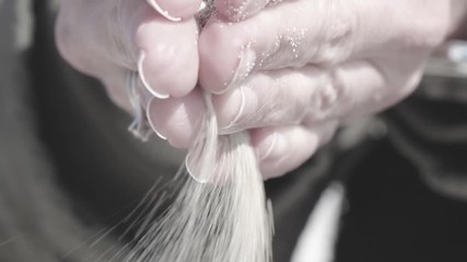 hands releasing fine sand, cinematic