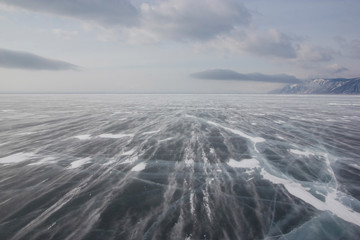 view of ice water surface under cloudy sky during daytime, russia, lake baikal