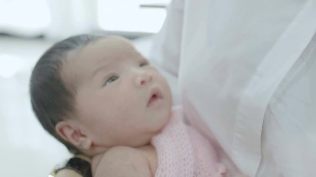 4K Slow motion Asian newborn baby sleeping peacefully over the mother chest