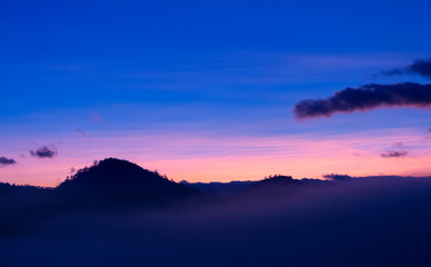 Beautiful orange light on mist mountain of fog when sunrise time. Mountain landscape in the north of Thailand