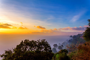 Fototapeta na wymiar Beautiful orange light on mist mountain of fog when sunrise time. Mountain landscape in the north of Thailand