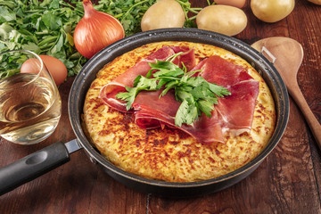A closeup photo of a Spanish tortilla with ingredients