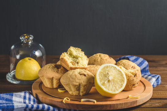 Lemon cupcakes on a wooden Board on the table with a blue towel. Free space for text.