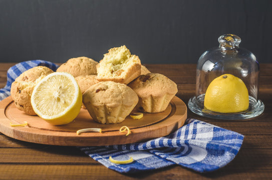 Lemon cupcakes on a wooden Board on the table with a blue towel. Free space for text.