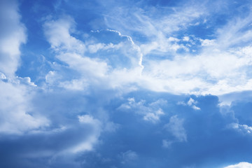 Blue sky background with white clouds.