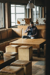 Businessman Sitting at Mountain Hotel Foyer