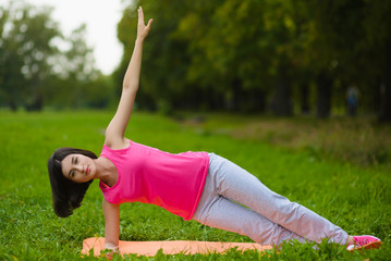 Fitness sport girl in sportswear doing yoga fitness exercise outdoor