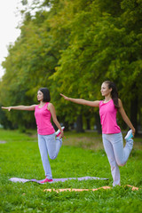 Fitness sport girls in sportswear doing yoga fitness exercise outdoor