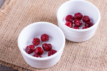 Cherry in ceramic form on a wooden table