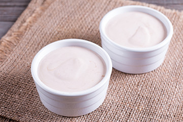Cottage cheese casserole in white ceramic form on a wooden table