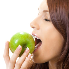 Cheerful woman eating apple, over white