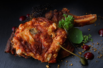 Meat on a bone with baked cheese