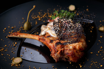 Meat on bone with mushrooms and sauce