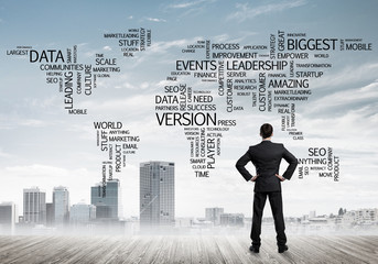 Motivation and inspiration concept with modern cityscape and businessman observing it