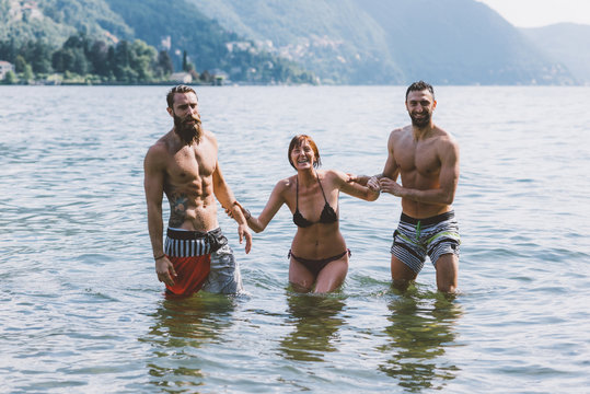 Portrait of three young adult friends in lake Como, Como, Lombardy, Italy