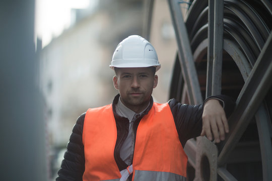 Road engineer standing by large wheel