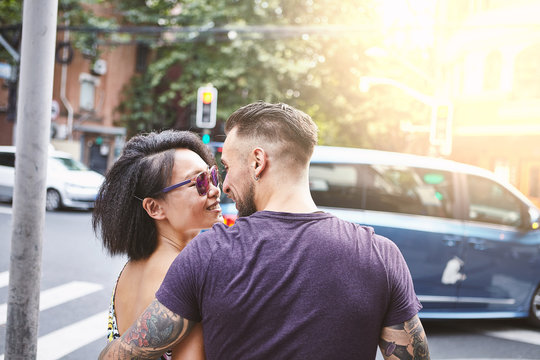 Multi ethnic hipster couple strolling along street, Shanghai French Concession, Shanghai, China