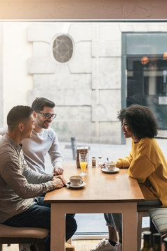 Group Of Happy Friends Chatting In The Coffee Shop.