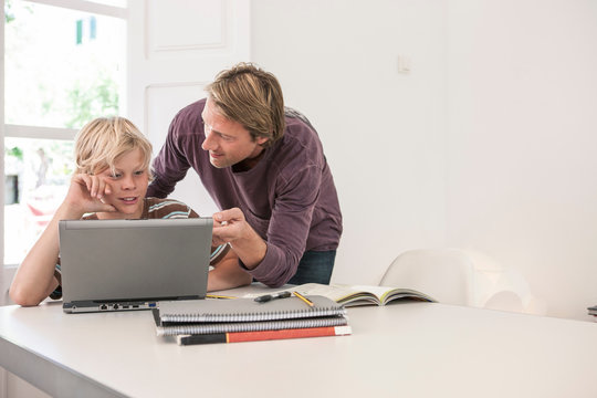 Father helping son with homework