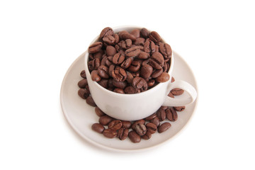 Coffee beans and a white cup on white background