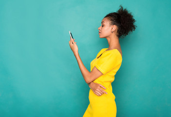 Young woman typing message on smartphone