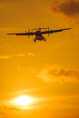 Fototapeta na wymiar Silhouette of the plane on a sunset background.