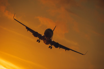 Fototapeta na wymiar Silhouette of the big plane on a sunset background.