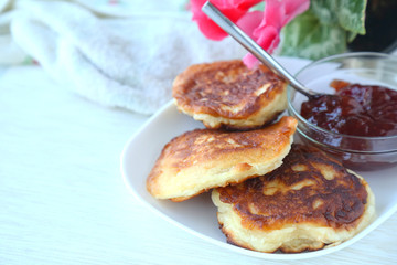 Homemade Fritters with jam on a white plate