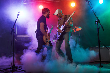 Guitarist and bass player perform on stage.