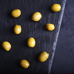 Green olives on black board