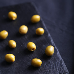 Tasty Green olives on black board