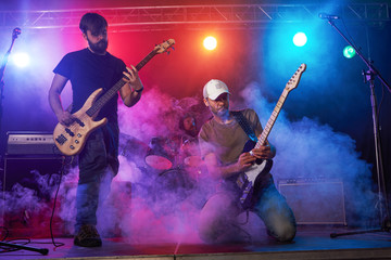 Guitarist and bass player perform on stage.