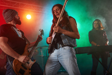 Guitarist and bass player perform on stage.