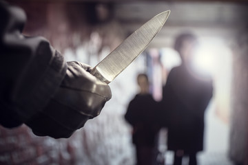 Criminal with knife weapon threatening woman in underpass crime - obrazy, fototapety, plakaty