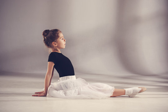 The little balerina dancer on gray background