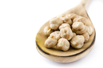 Chickpeas on wooden spoon isolated on white background

