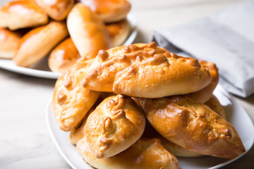 Traditional Russian baked pies (pirozhki). Close-up, selective focus.