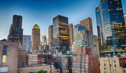 Midtown Manhattan skyscrapers as seen from city rooftop at sunset