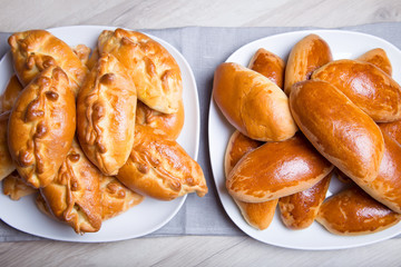 Traditional Russian baked pies (pirozhki). Close-up, selective focus.