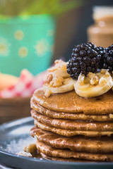 Close up of pancakes with fresh blackberries,banana and walnut
