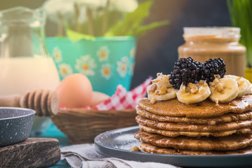 Pancakes served on spring themed table