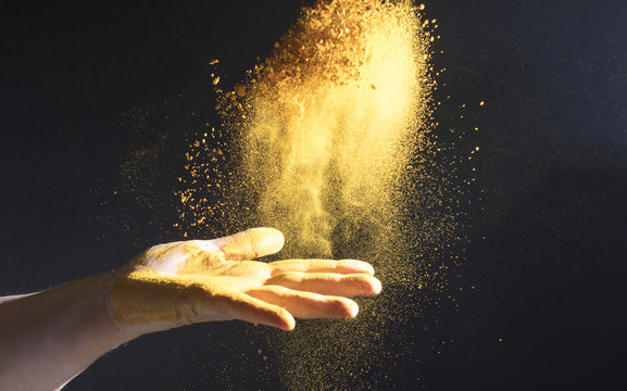 Turmeric spice being thrown into the air 
